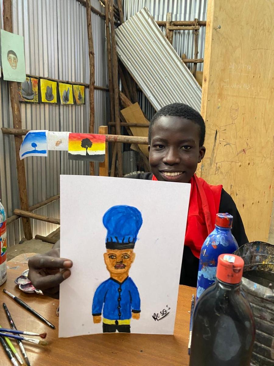 Kind aus der Malschule Kibera mit Bild