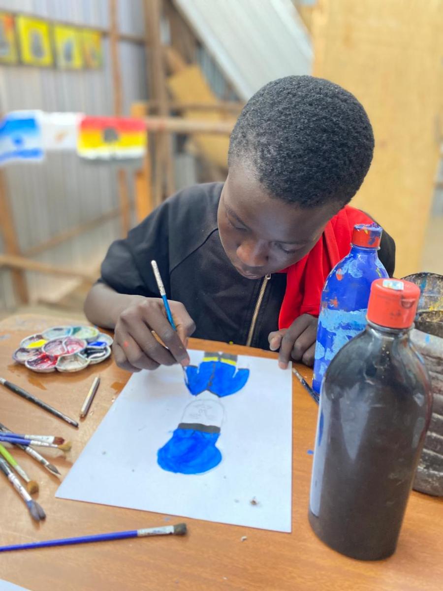 Kind aus der Malschule Kibera mit Bild
